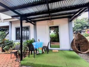 a patio with a table and chairs in a house at Yaga's Stay INN save in Impasugong +30 photos
