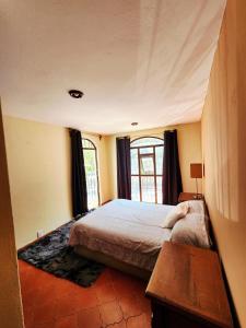 a bedroom with a bed and a window at Room with Parking near the Center in Guanajuato +16 photos