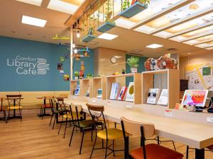 a restaurant with a counter with chairs and tables at Comfort Hotel Hakata in Fukuoka +24 photos