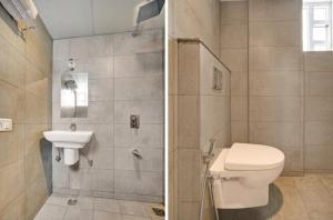 a bathroom with a toilet and a sink at Aeon Hotel in Bengaluru +79 photos