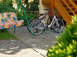 a bike parked next to a swing and a chair at Skiapartman in Batizovce