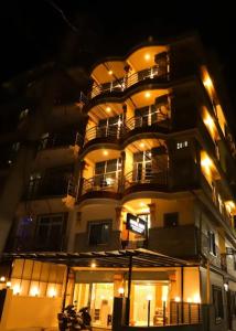 a building with balconies on the side of it at night at Hotel Lekali Pvt Ltd in Pokhara +5 photos