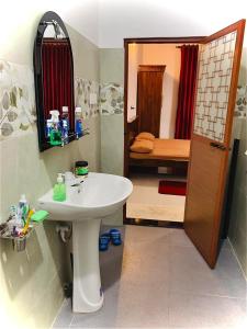 a bathroom with a sink and a room with a bedroom at Serenity Stay in Nikawatawana