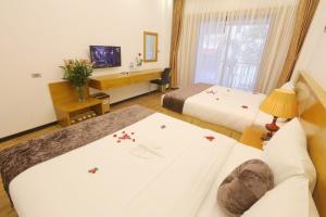 Postel nebo postele na pokoji v ubytování Family Hanoi Hotel