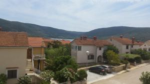 a view of a town with houses and a car at Apartment Diminic Melin in Cres