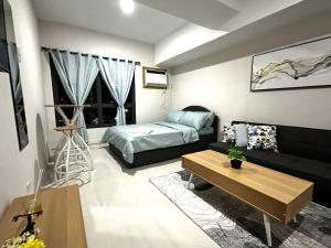 a living room with a couch and a bed at Athenas Cozy Place in Mandaue City +11 photos