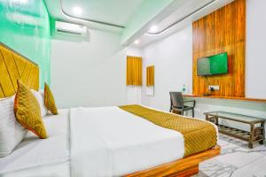 a hotel room with a bed and a desk at FabHotel New 7 Star in Mumbai