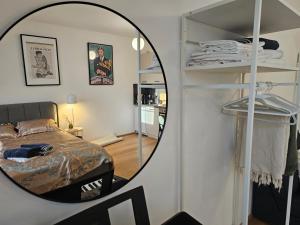 a mirror in a room with a bed and a bedroom at Private Studio Central Vienna in Vienna