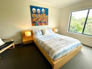 una camera da letto con un letto e un quadro sul muro di Just Beachy a Island Beach