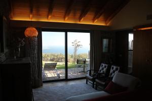 a living room with a large sliding glass door at Quinta Vale da Roca in Sintra