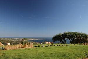 a fence on a field with a view of the ocean at Quinta Vale da Roca in Sintra