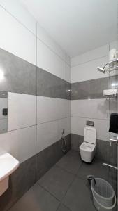a bathroom with a toilet and a sink at Grand Beach Villa in Kannur