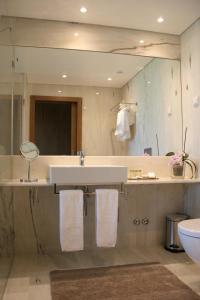 a bathroom with a sink and a mirror at Quinta Vale da Roca in Sintra