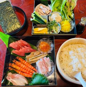 a table with three trays of different types of food at Toyotakeyashiki - Vacation STAY 37187v in Towa