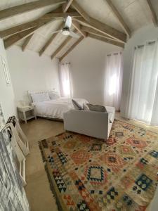 a living room with a couch and a bed at Five Kingsway in Knysna