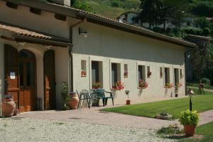 a house with a patio and a table in front of it at Azienda Agrituristica La Valle del Sambuco in Norcia