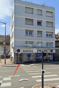 a building with a street sign in front of it at Chaleureux T2 Centre Ville in Montbéliard +6 photos