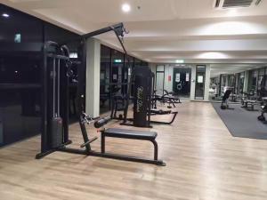 a gym with several treadmills and machines in it at idamanKu Comfort Studio 4pax - HYVE SOHO Cyberjaya in Cyberjaya