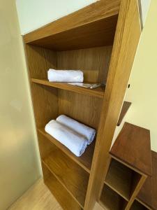 a wooden closet with two towels in it at Sienna Living Setiabudi in Jakarta