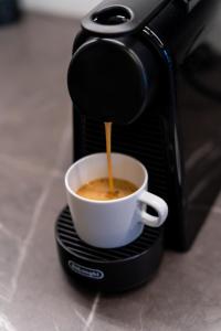 a coffee maker is making a cup of coffee at Studio 5 Min to Riga Old Town & Christmas Market in Rīga +18 photos