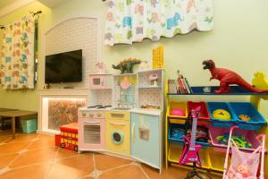 una sala de juegos para niños con una estufa de juguete y una cocina de juego en The Anderson Manor Hotel, en Ruisui