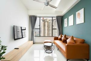 a living room with a couch and a large window at Rivergate Apartment Central in HCM City in Ho Chi Minh City