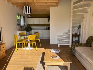a living room with a couch and a table at HÔME Les hauts du Val in Vantoux +7 photos