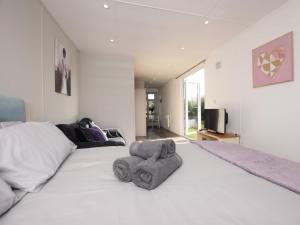 a bedroom with a large white bed with a large window at 1 Bed in Thetford 76493 in East Harling