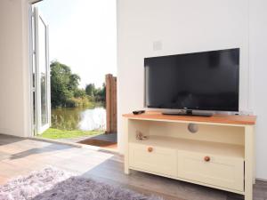a television on a dresser in a room with a window at 1 Bed in Thetford 76493 in East Harling +11 photos