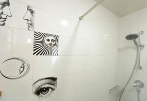 a bathroom with black and white pictures on the wall at Hotel La Alfonsina in Santibáñez de Villacarriedo
