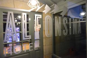 a store with a sign on the front of a door at Hotel La Alfonsina in Santibáñez de Villacarriedo
