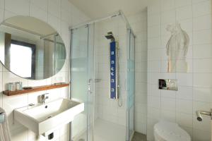 a bathroom with a sink and a glass shower at Hotel La Alfonsina in Santibáñez de Villacarriedo