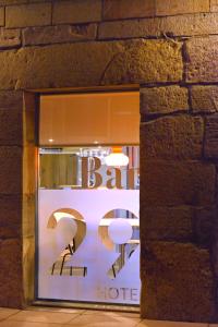 a store window with a sign in a brick wall at Hotel La Alfonsina in Santibáñez de Villacarriedo