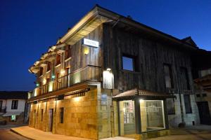 a building with a sign on the side of it at Hotel La Alfonsina in Santibáñez de Villacarriedo