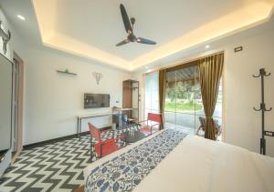 a bedroom with a bed and a living room at Vanvasa Ranakpur by Samav in Sādri +15 photos