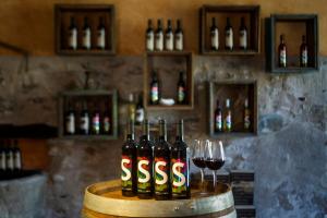 - un groupe de bouteilles de vin sur un fût avec des verres à vin dans l'établissement Ligüerre Resort, à Ligüerre de Cinca