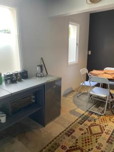 a kitchen with a counter and a table with a kettle on it at Five Kingsway in Knysna