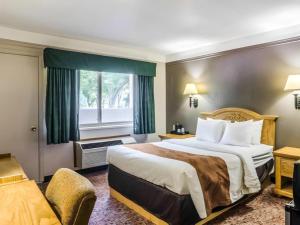 a hotel room with a bed and a window at Quality Inn in Buffalo +106 photos