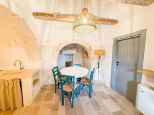 a kitchen with a table and chairs in a room at Borgo Cucumo by MONHOLIDAY in Castellana Grotte