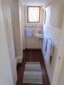 a white bathroom with a sink and a toilet at Caledon 31 in George