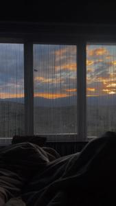a bed in a room with a window with a view at Panorama Lupilor in Coleşti