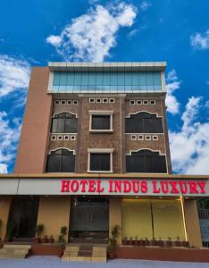 a hotel indus luxury building with a sign on it at Hotel Indus Luxury in Bhubaneshwar