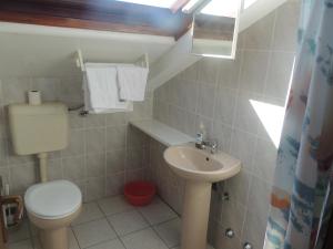 a small bathroom with a toilet and a sink at Villa Ana in Bol +23 photos