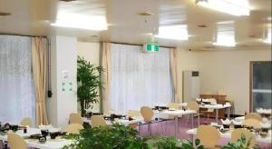 a room with tables and chairs in a room at Kinugawa Niouson Plaza Hotel in Nikko