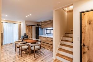 a kitchen and dining room with a table and chairs at Apartment Hotel 11 Villa Hanazonocho in Osaka