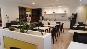 a restaurant with tables and chairs and a counter at Hotel San Marco BB in Boario Terme