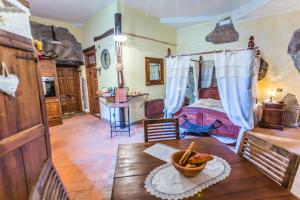 a room with a bed and a table with a bowl of food on it at Frantoro - alloggio turistico - in Viterbo