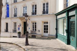 a street with a light pole in front of a building at Timhotel Montmartre in Paris +52 photos