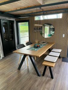 a dining room table with two chairs and a mirror at Hausboot Arneburg in Arneburg +18 photos