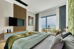 a bedroom with a large bed and a television at Baltic Infinity in Międzyzdroje +137 photos